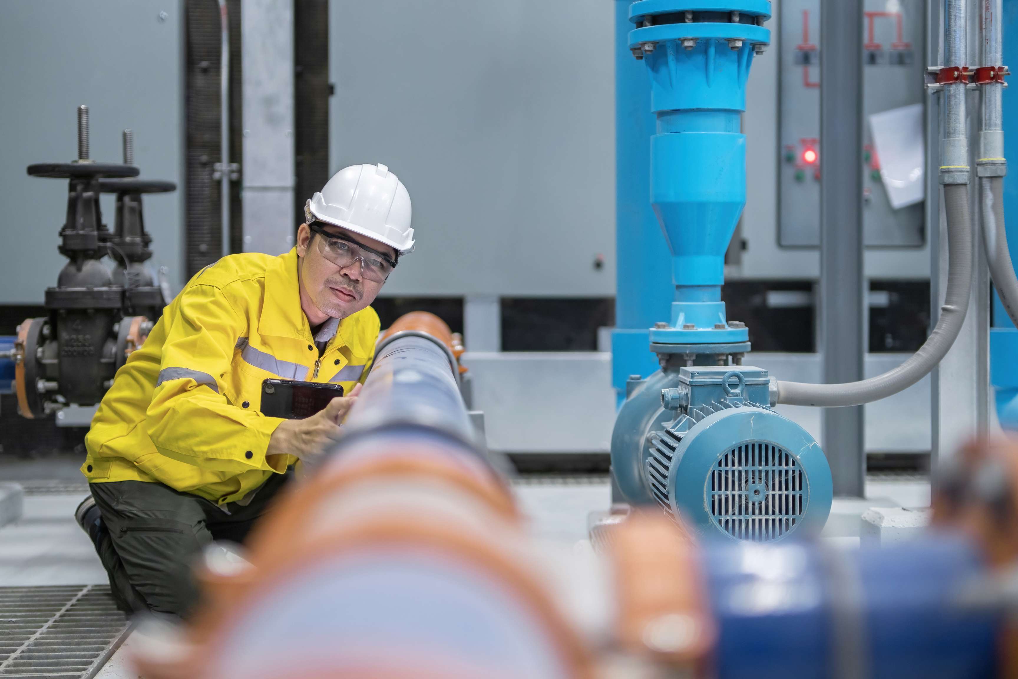 Rosenxt Engineer examining water pump and water supply at industrial Test Pipes.