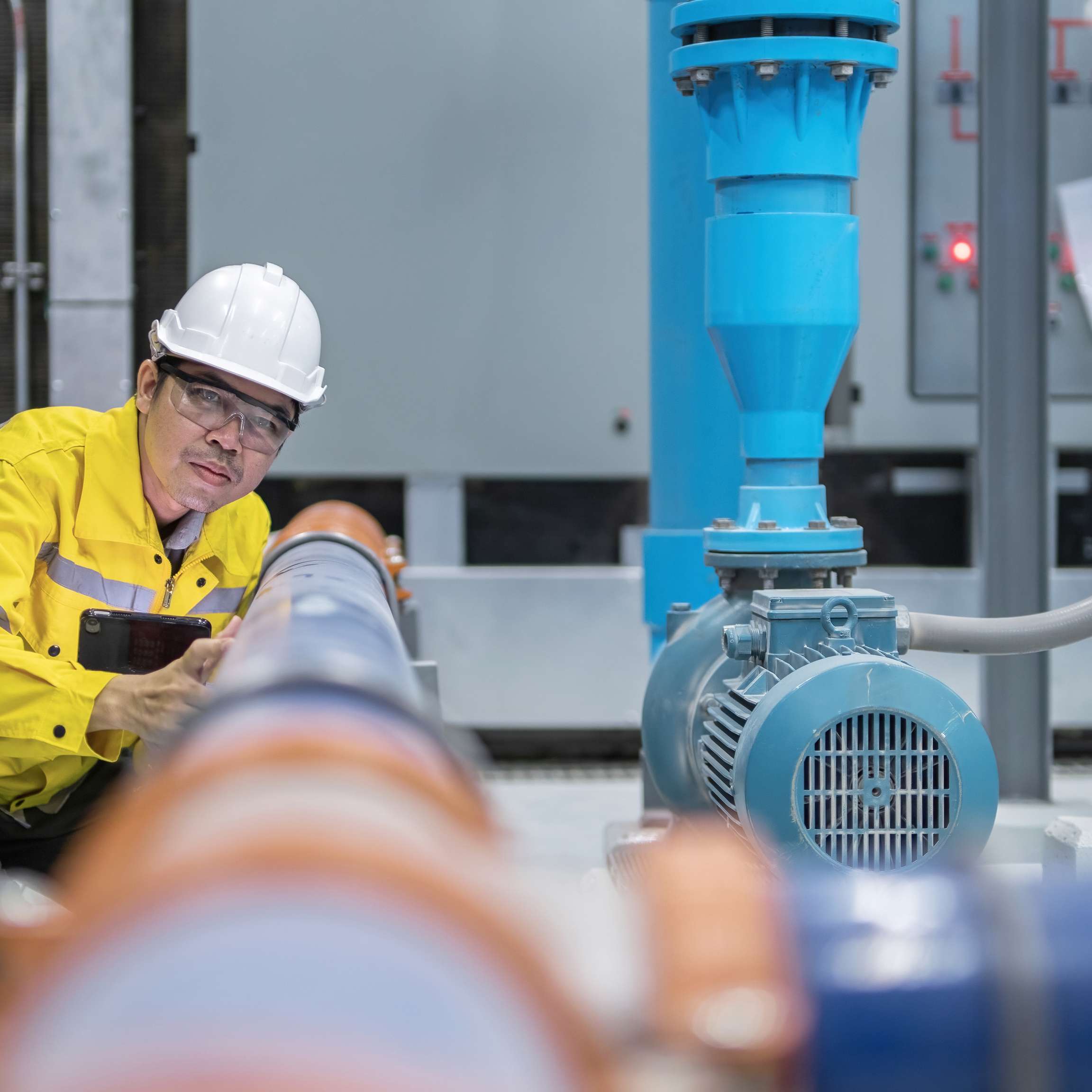 Rosenxt Engineer examining water pump and water supply at industrial Test Pipes.