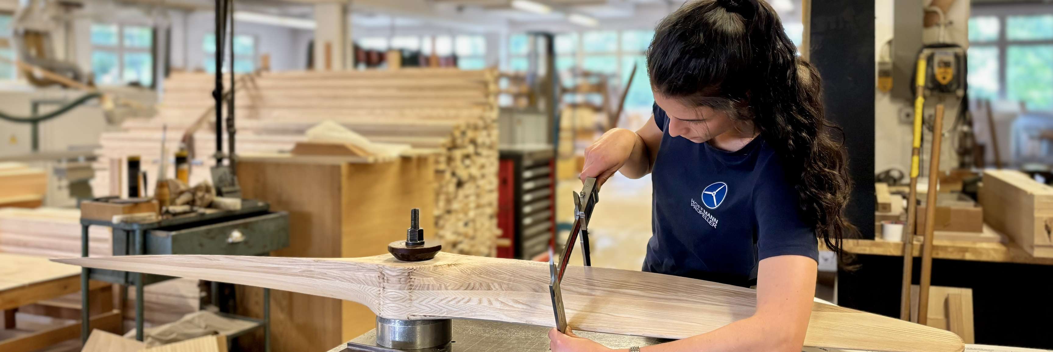 A Hoffmann propeller technician measures a wooden propeller