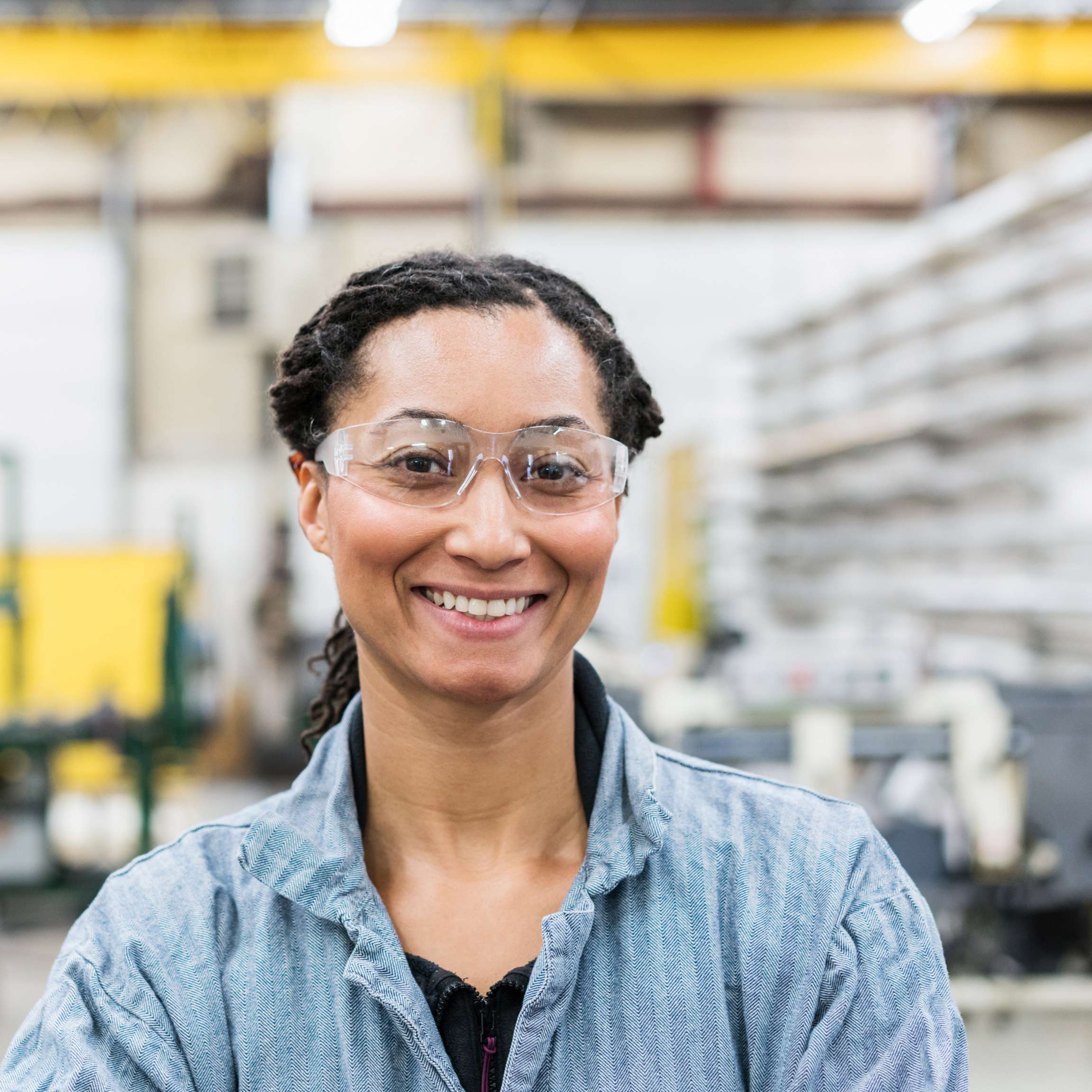 Rosenxt Young woman standing in factory building.